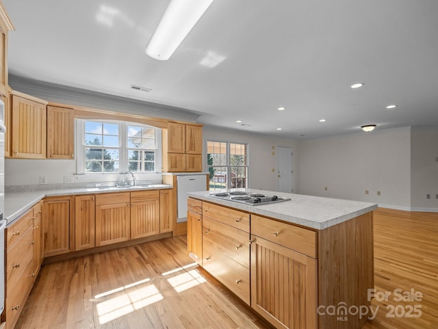 kitchen with visible vents, electric cooktop, a sink, white dishwasher, and light wood finished floors