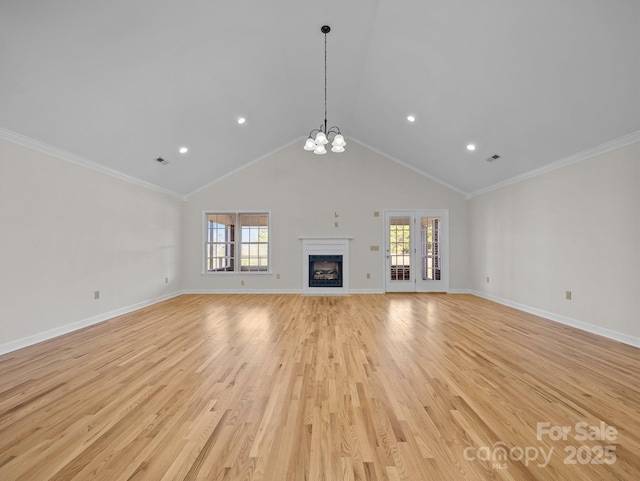 unfurnished living room featuring an inviting chandelier, light wood-style floors, visible vents, and baseboards