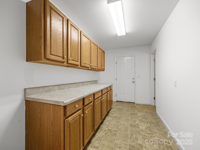 washroom featuring baseboards