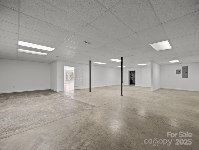 basement with electric panel, baseboards, visible vents, and a drop ceiling