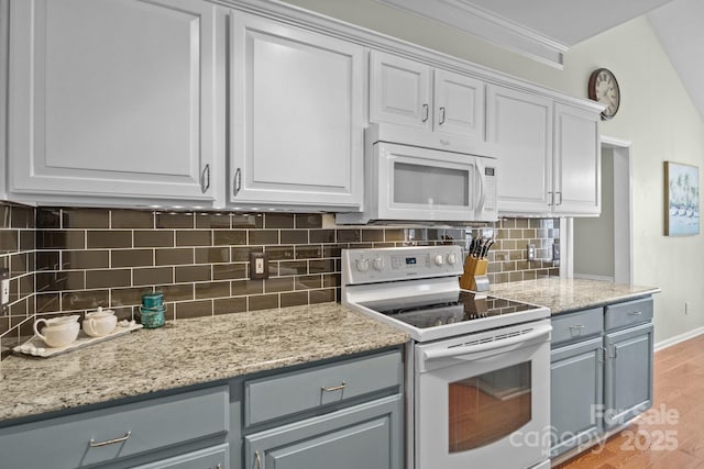 kitchen with backsplash, gray cabinetry, light wood-type flooring, white cabinets, and white appliances