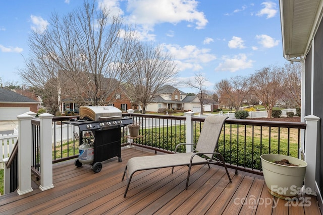 deck with a yard, a residential view, and a grill