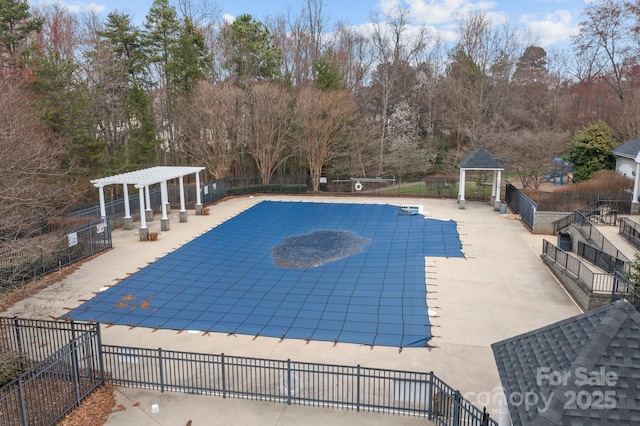 community pool featuring a patio area, fence, and a pergola