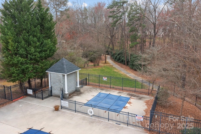 community pool featuring fence, a shed, a lawn, an outbuilding, and a patio