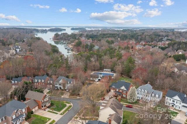 drone / aerial view with a residential view and a water view