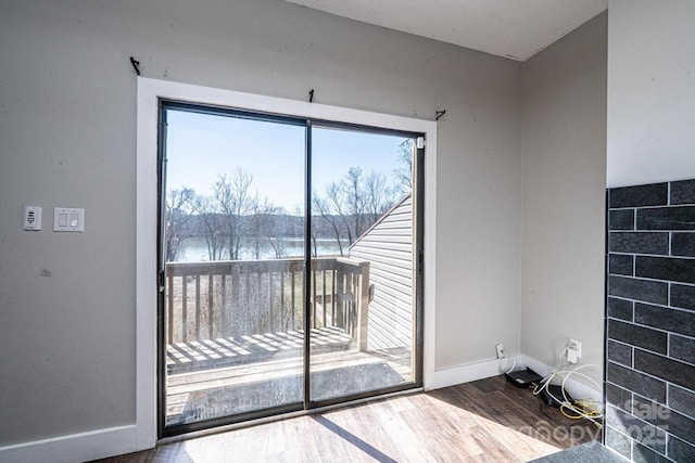 interior space featuring baseboards and wood finished floors