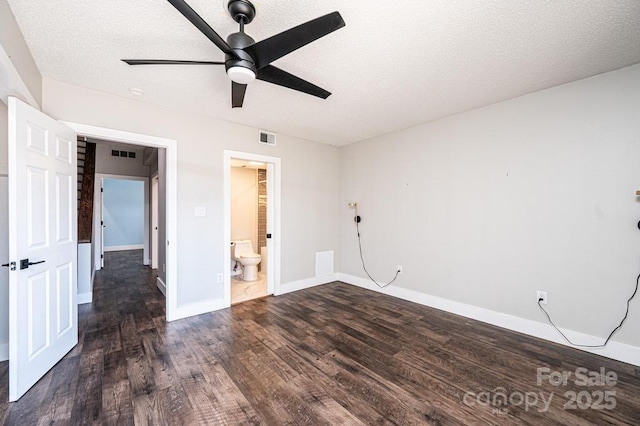 unfurnished bedroom with visible vents, baseboards, a textured ceiling, and wood finished floors