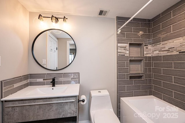 bathroom with visible vents, toilet,  shower combination, and vanity