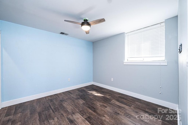 spare room featuring visible vents, wood finished floors, baseboards, and ceiling fan