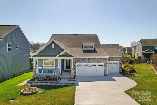 view of front of property with a garage, driveway, covered porch, and a front yard