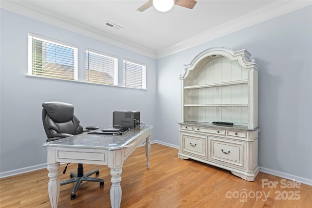 office space featuring visible vents, baseboards, light wood-type flooring, ornamental molding, and a ceiling fan