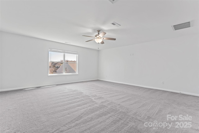 unfurnished room with visible vents, baseboards, carpet, and ceiling fan