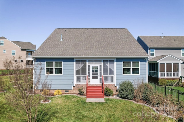 back of house with a lawn, fence, a sunroom, and a shingled roof