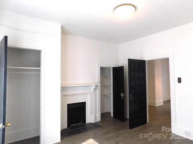 unfurnished living room featuring wood finished floors and a fireplace