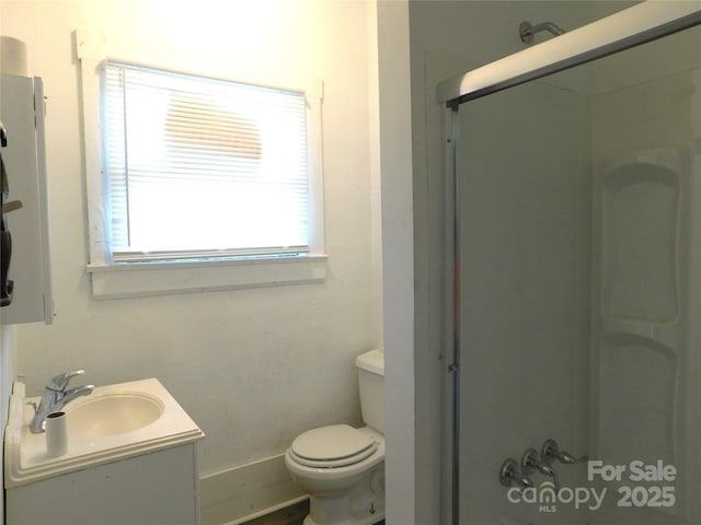 full bath featuring toilet, vanity, and a shower