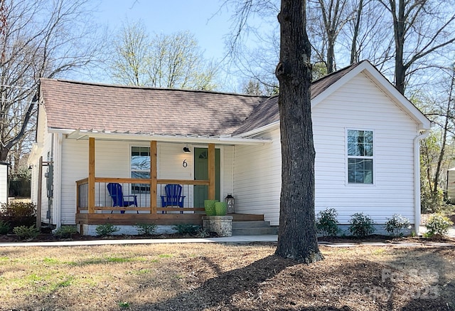 view of front of home featuring covered porch and roof with shingles