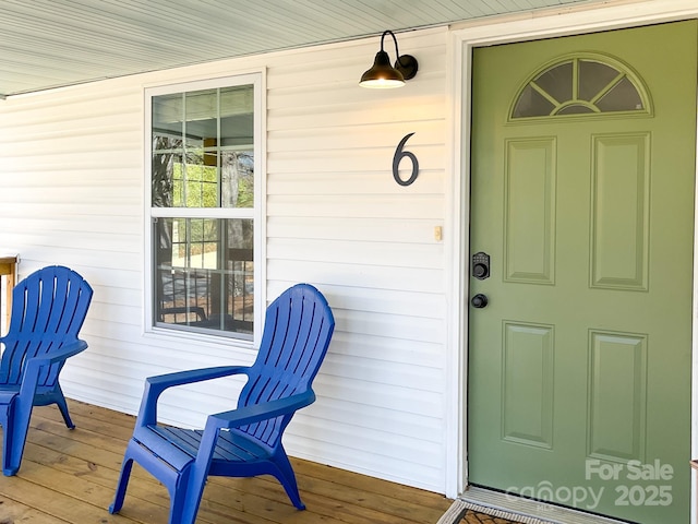 view of exterior entry with a porch