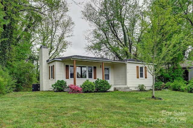 110 Maplewood Knoll Dr, East Flat Rock, NC 28726 - view of front of house with a front yard, central AC unit, and a chimney