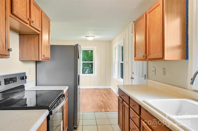 110 Maplewood Knoll Dr, East Flat Rock, NC 28726 - kitchen featuring light countertops, a sink, brown cabinetry, and stainless steel range with electric cooktop