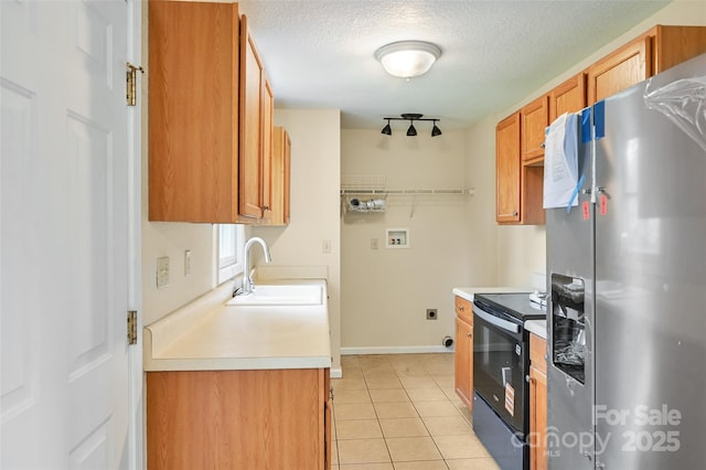 110 Maplewood Knoll Dr, East Flat Rock, NC 28726 - kitchen featuring electric stove, light tile patterned floors, stainless steel fridge, light countertops, and a sink