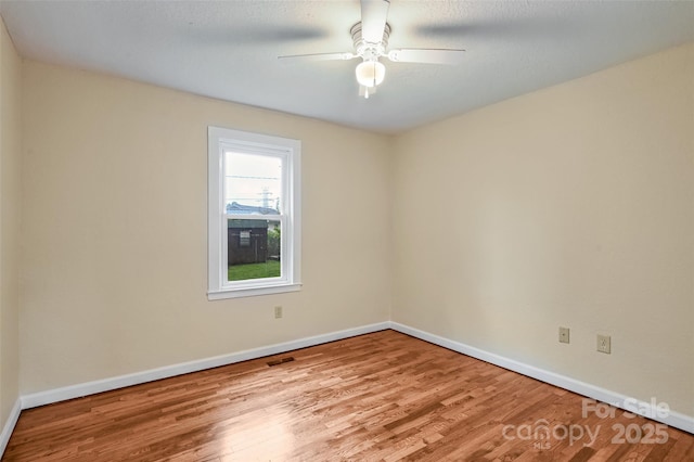 110 Maplewood Knoll Dr, East Flat Rock, NC 28726 - spare room with wood finished floors, a ceiling fan, visible vents, and baseboards