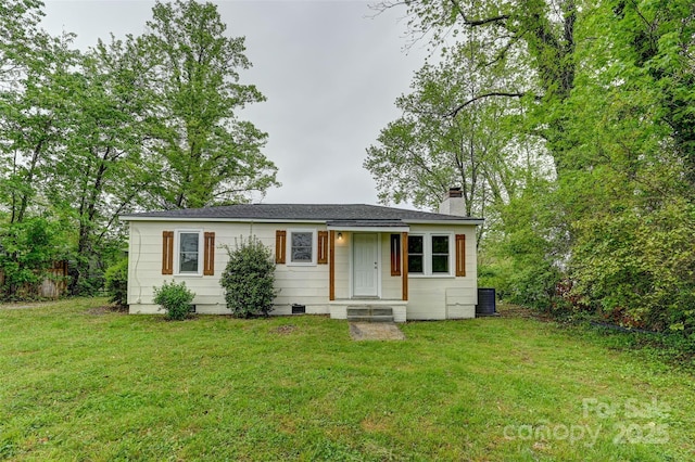 110 Maplewood Knoll Dr, East Flat Rock, NC 28726 - view of front of house featuring a chimney, central AC unit, and a front lawn
