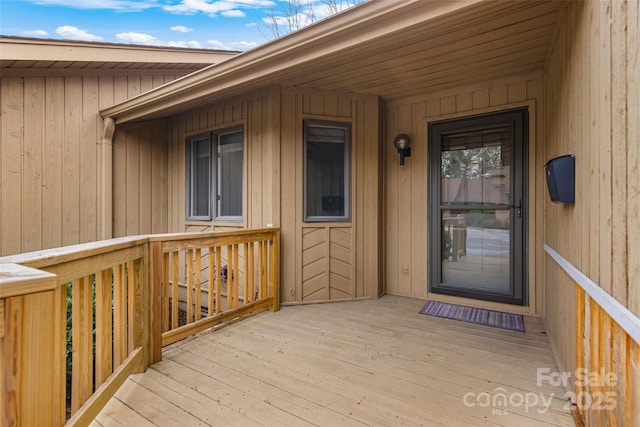 property entrance featuring a wooden deck