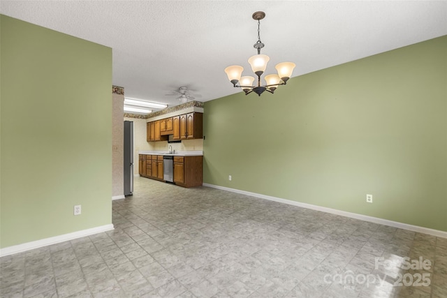 unfurnished living room with ceiling fan with notable chandelier, light floors, a textured ceiling, and baseboards