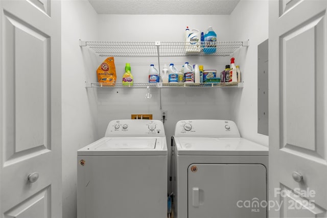 laundry area with a textured ceiling, laundry area, and washer and clothes dryer