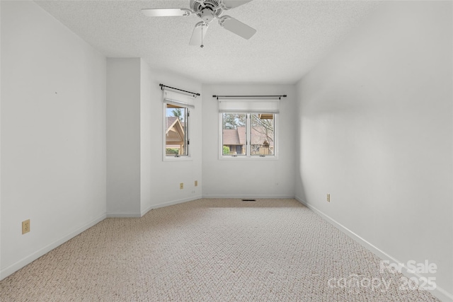 unfurnished room with baseboards, a textured ceiling, a ceiling fan, and carpet floors