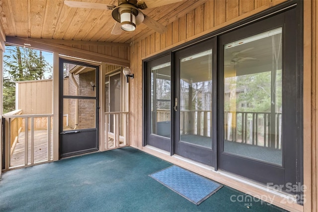 view of exterior entry featuring a ceiling fan