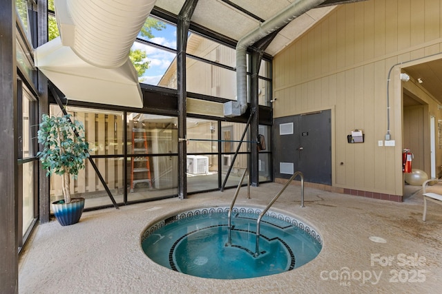 view of pool with a swimming pool, central AC, and an indoor hot tub