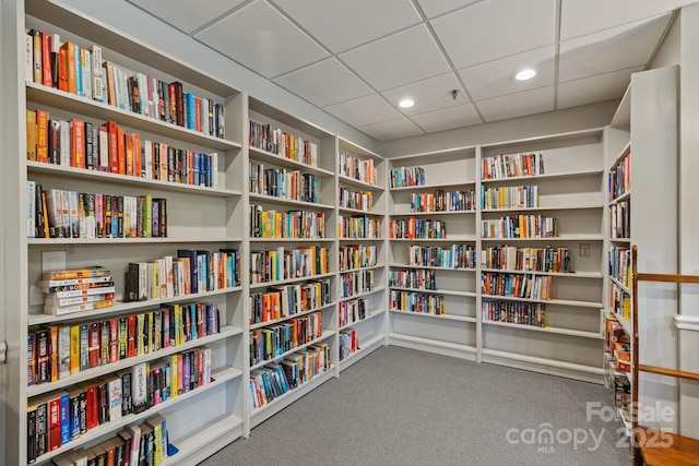 interior space with carpet flooring, recessed lighting, and wall of books