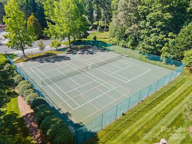 view of sport court featuring a lawn and fence