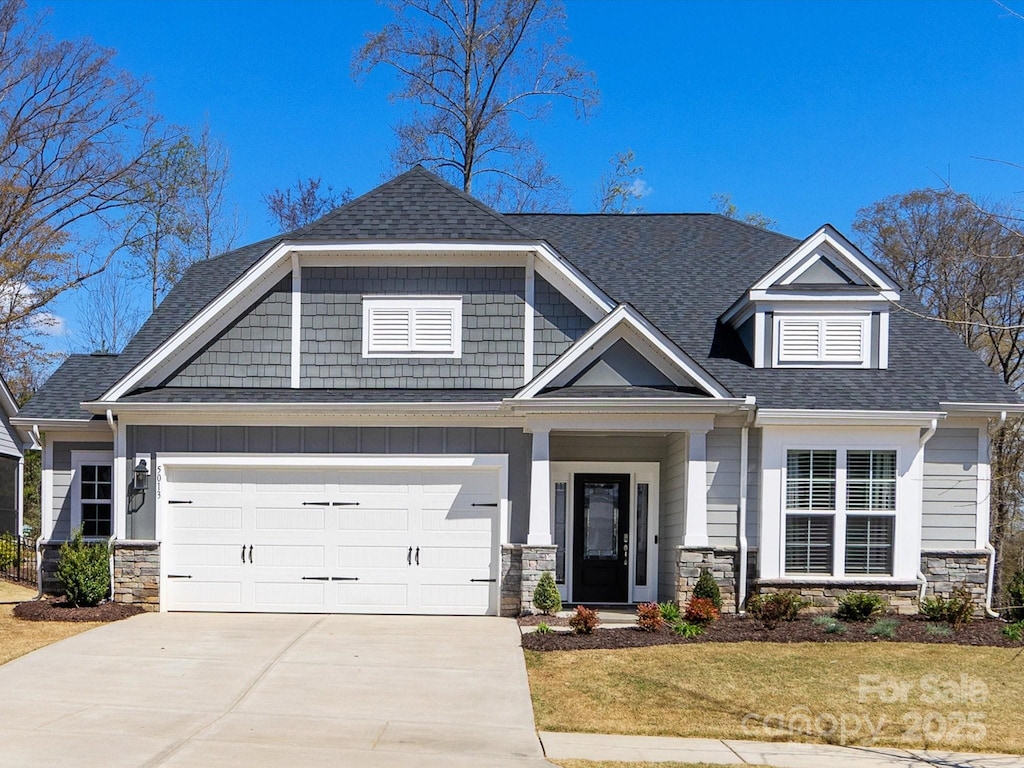 5013 Watercrest Trl, Belmont, NC 28012 - craftsman-style house featuring concrete driveway, an attached garage, stone siding, a front lawn, and a shingled roof