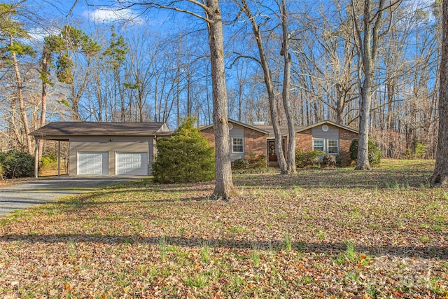 view of front of property with aphalt driveway and a carport