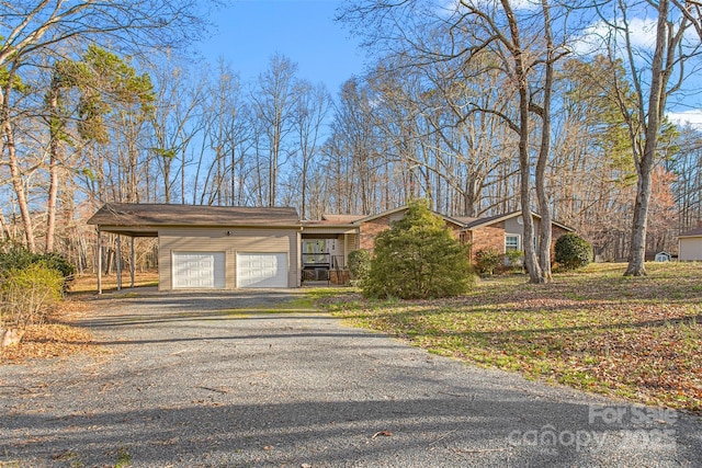 view of front of property with gravel driveway and an attached garage