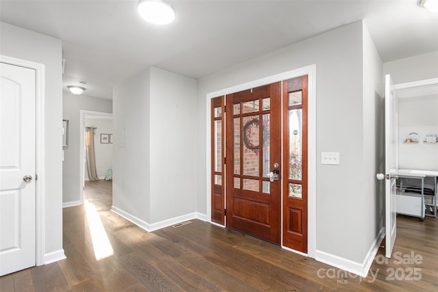 entrance foyer featuring baseboards and dark wood finished floors