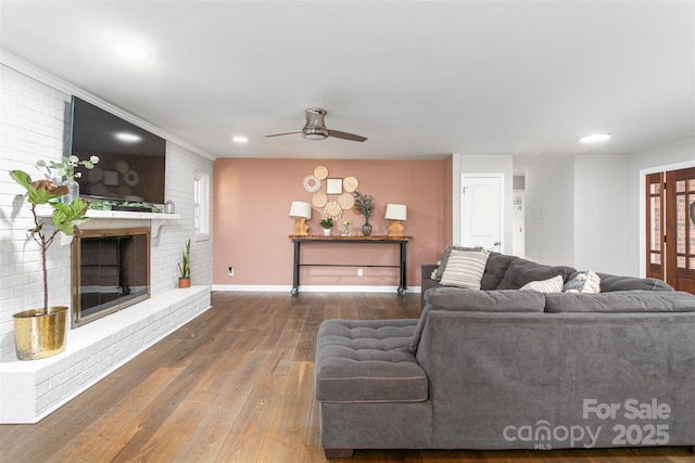 living area with hardwood / wood-style floors, recessed lighting, a fireplace, baseboards, and ceiling fan