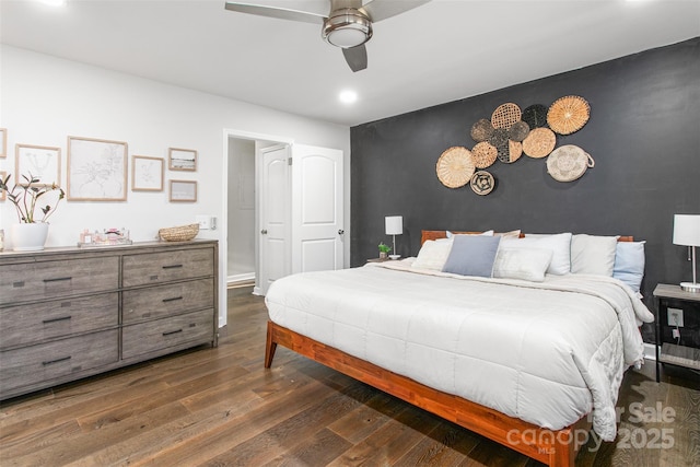 bedroom with a ceiling fan, baseboards, recessed lighting, dark wood-style flooring, and an accent wall