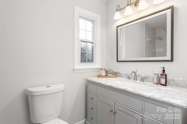 bathroom with toilet and vanity