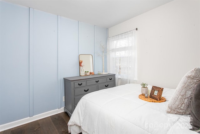 bedroom with dark wood-style floors