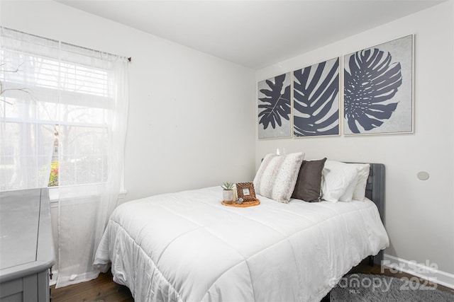 bedroom featuring dark wood-style floors and baseboards