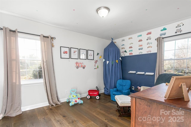 bedroom with wood finished floors and baseboards