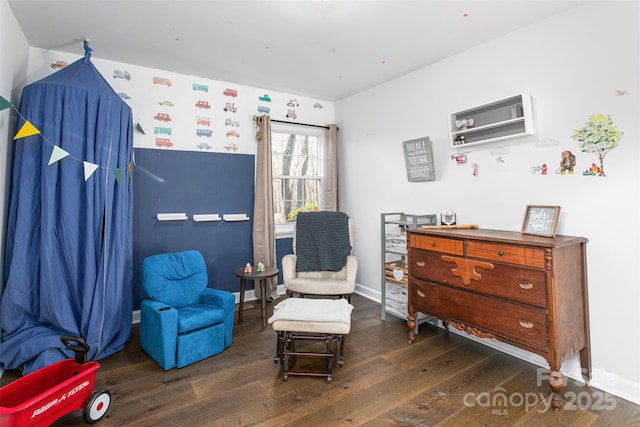 sitting room featuring baseboards and hardwood / wood-style floors