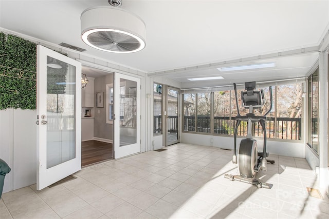 workout area featuring french doors, visible vents, and tile patterned flooring