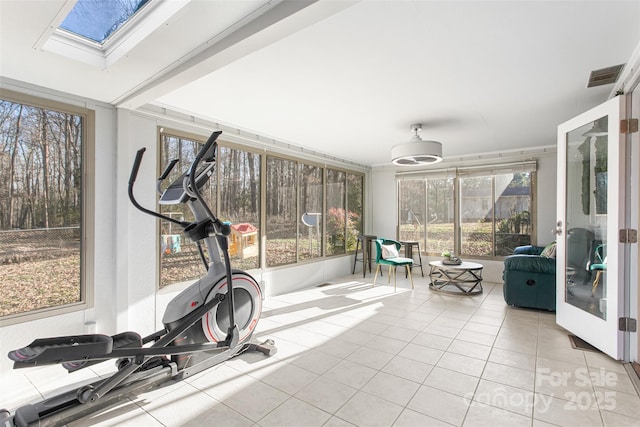 exercise area with french doors, visible vents, a skylight, and tile patterned flooring