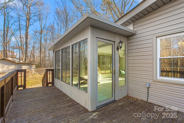 wooden deck with a sunroom