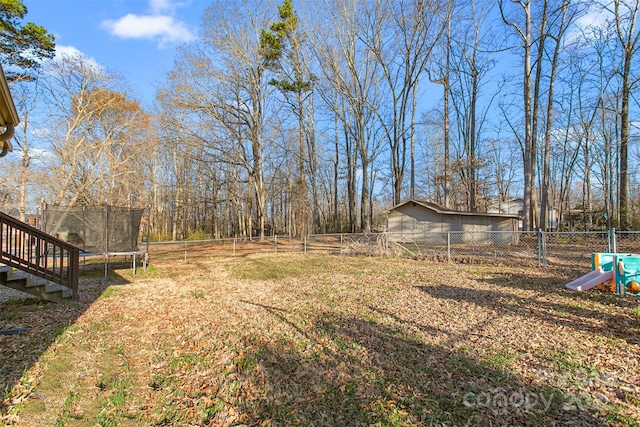 view of yard featuring a fenced backyard and a trampoline