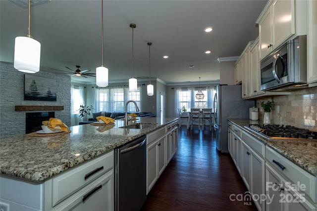 246 Sweet Briar Dr, Fort Mill, SC 29707 - kitchen with backsplash, white cabinets, stainless steel appliances, a ceiling fan, and a sink